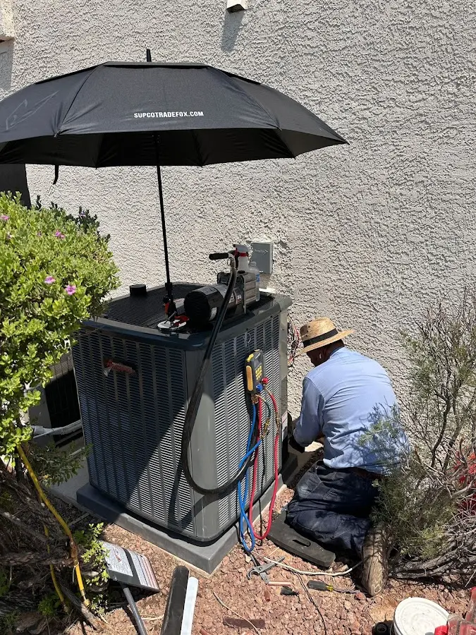HVAC technician performing outdoor AC maintenance in Jordan